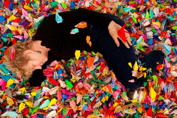 Patrice Demmon lounges in her folded paper cranes