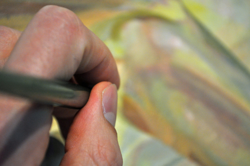 Paul X. Rutz works on a painting in this tight close-up. 