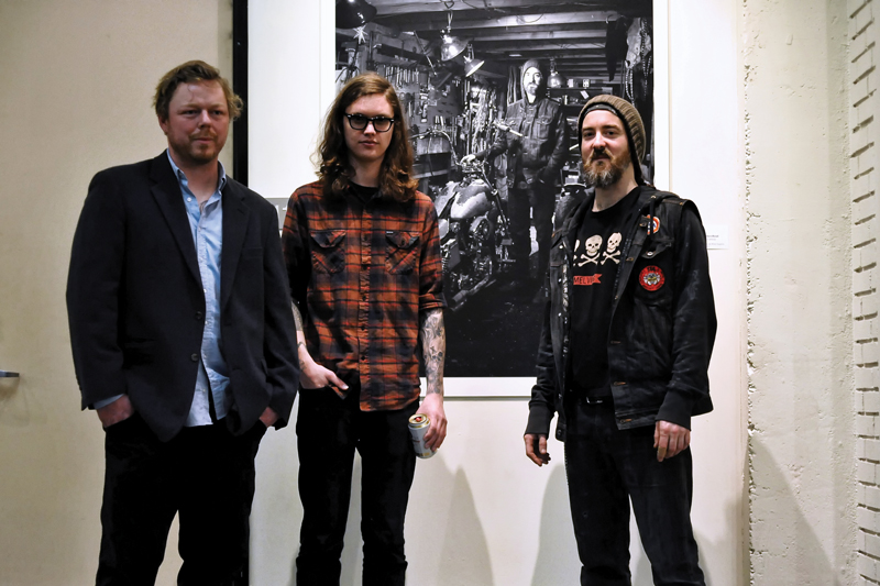 Left to right: Jason Coatney, Jordan Conway and Tony Morgan with one of Conway's photographs. 