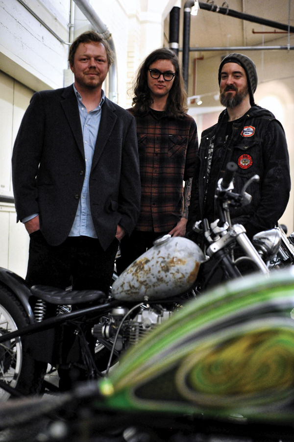Left to right: Jason Coatney, Jordan Conway and Tony Morgan amidst Morgan’s motorcycle exhibit.